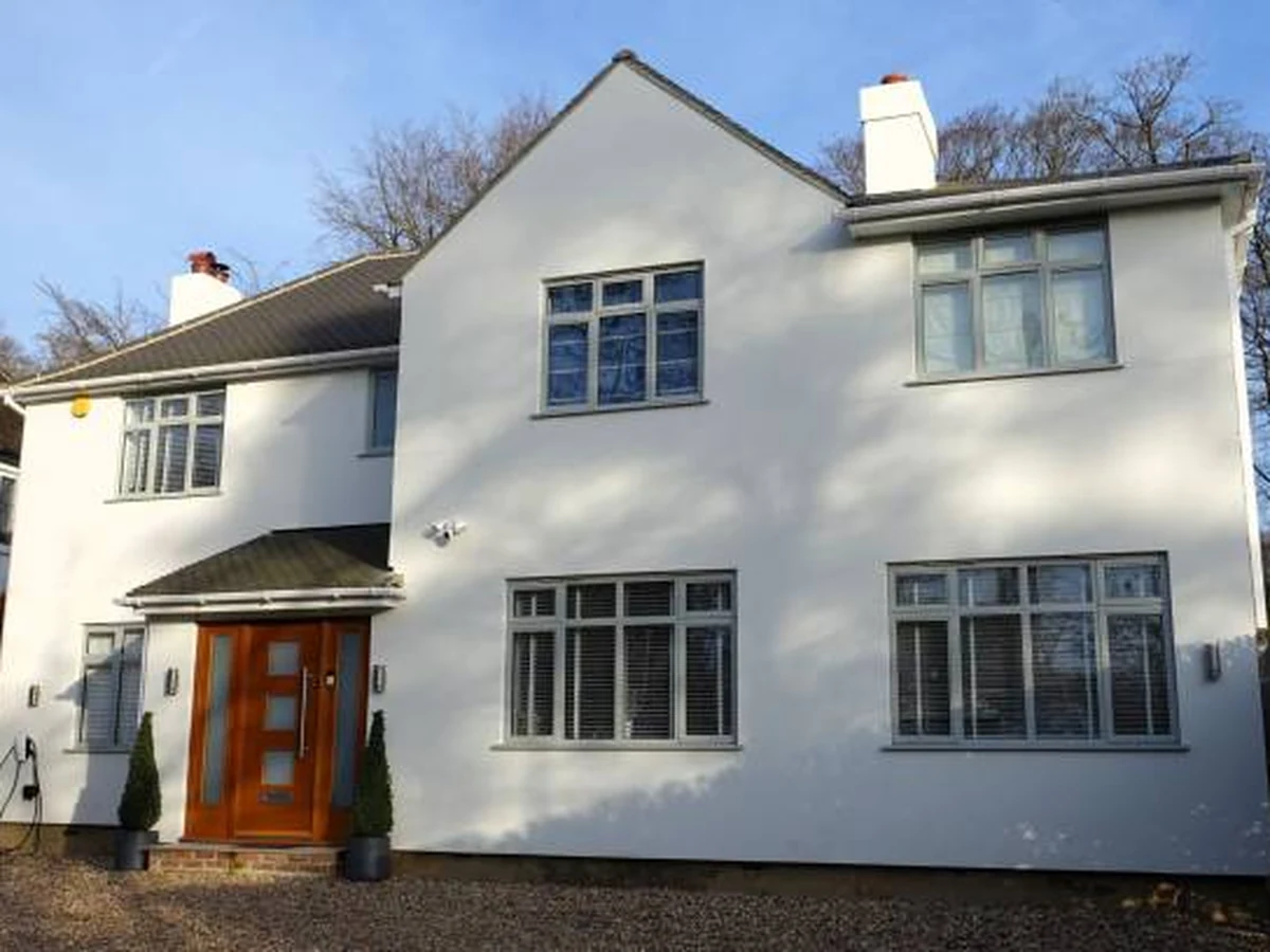 White rendered detached house with exterior painting in Winchester by Winchester Decorators